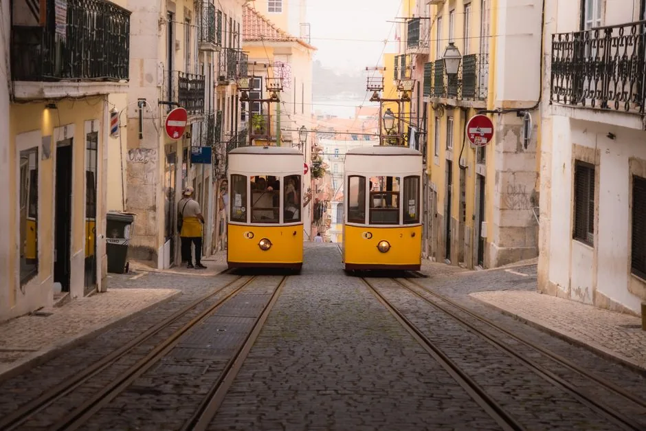 The iconic yellow Tram 28 navigates the steep inclines of Lisbon, serving as both a primary transport method and a budget-friendly sightseeing tour.
